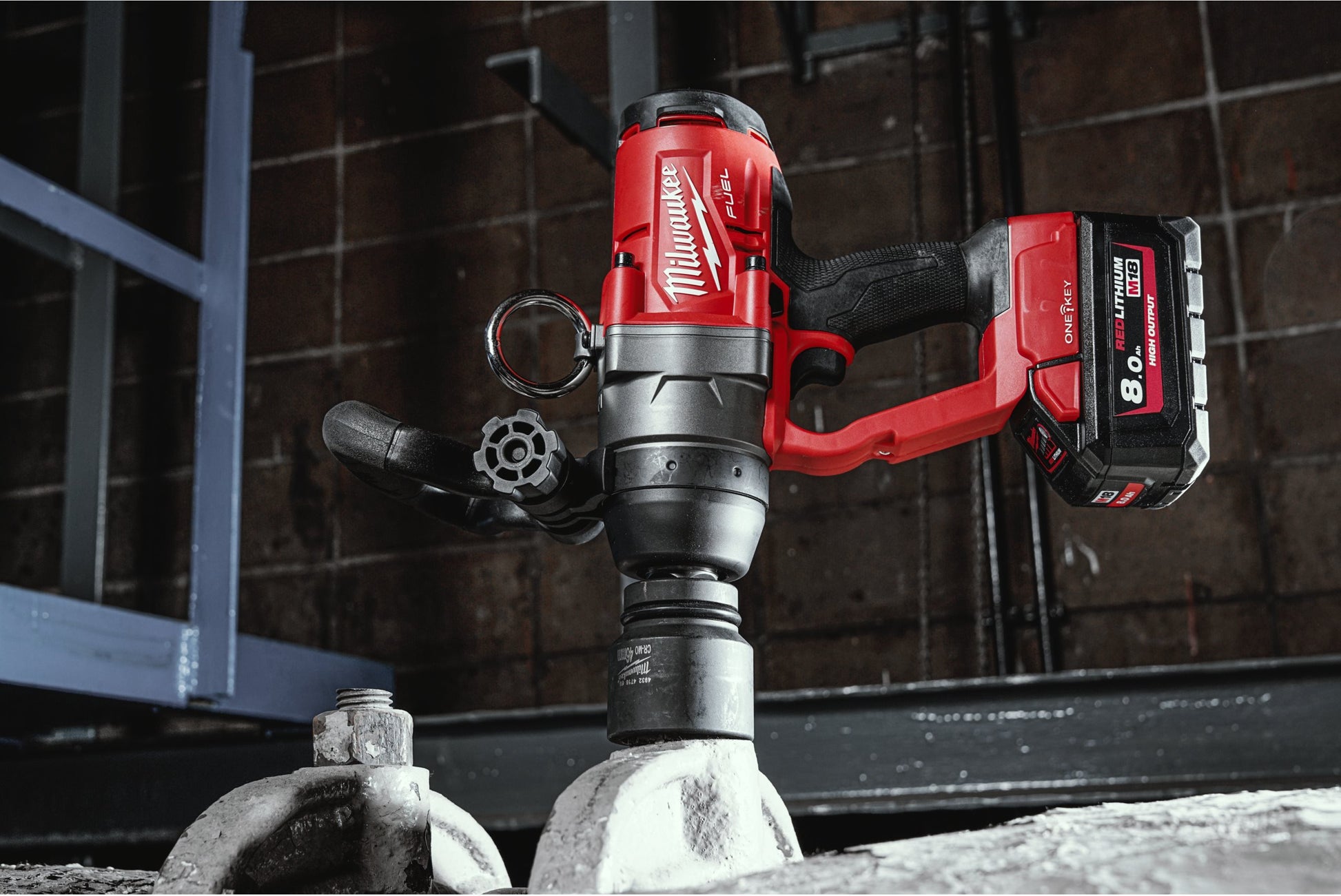 Red and black Milwaukee 1" High Toque Impact Wrench on a construction site background