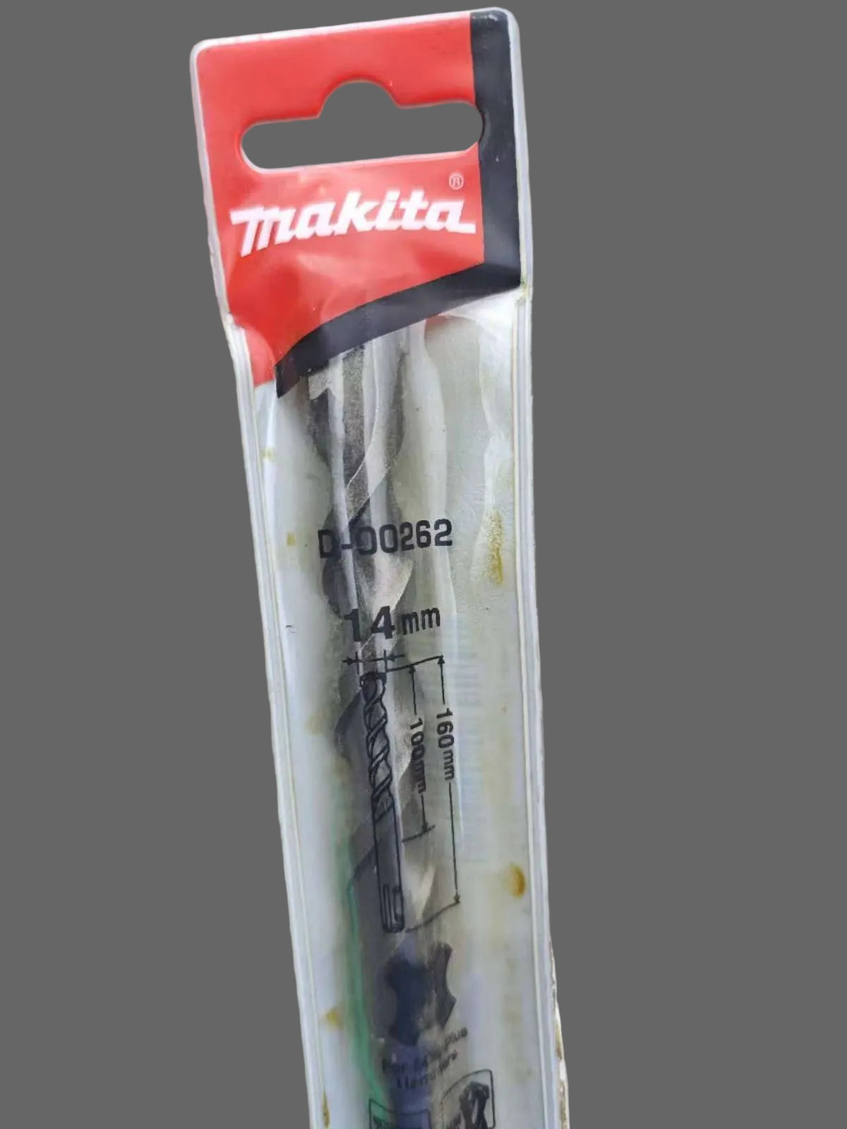 Makita drill bit in packaging on a concrete surface