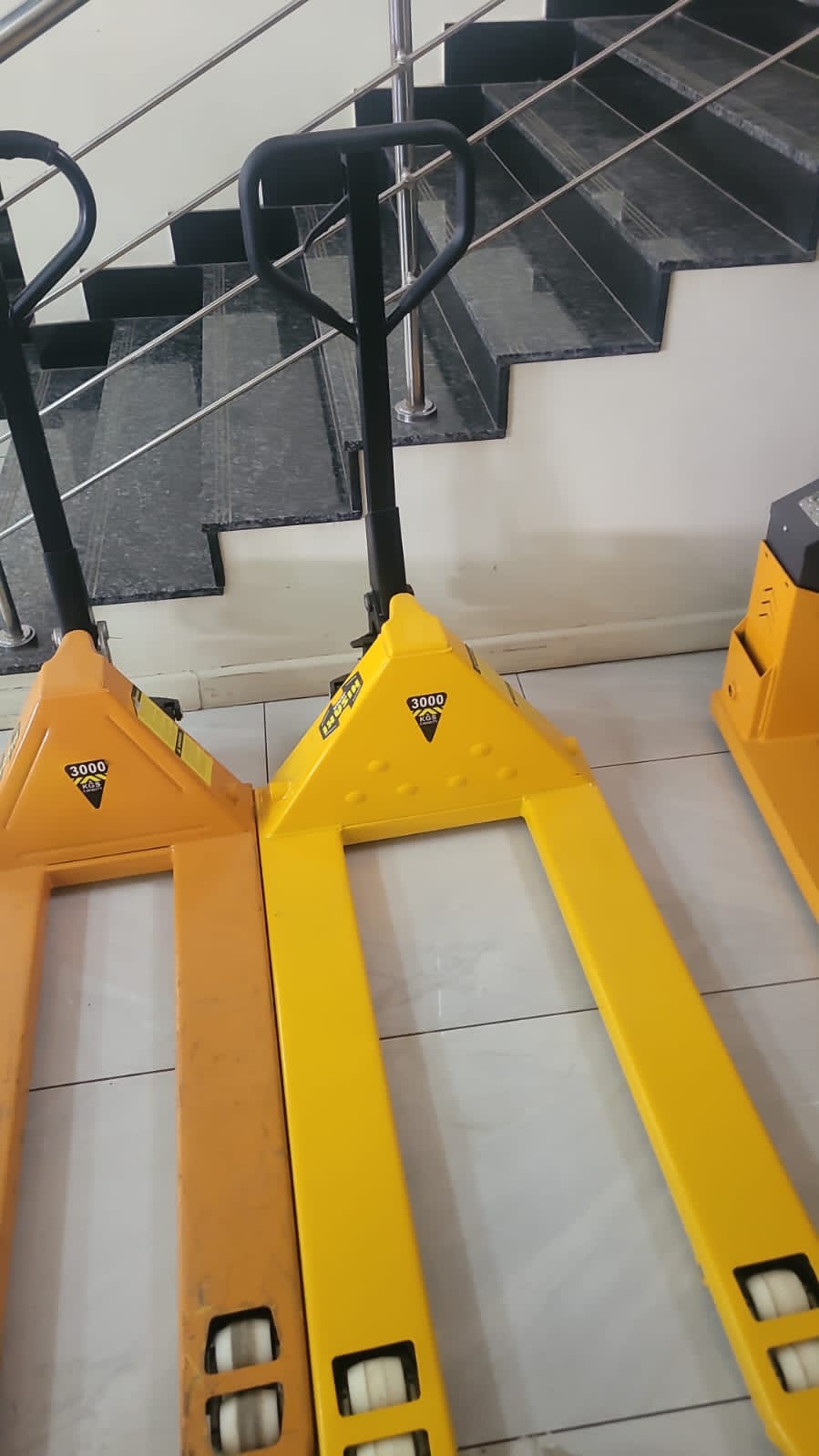 Hisaki 3-ton wide pallet trucks indoors showing fork detail and 3000kg rating badge