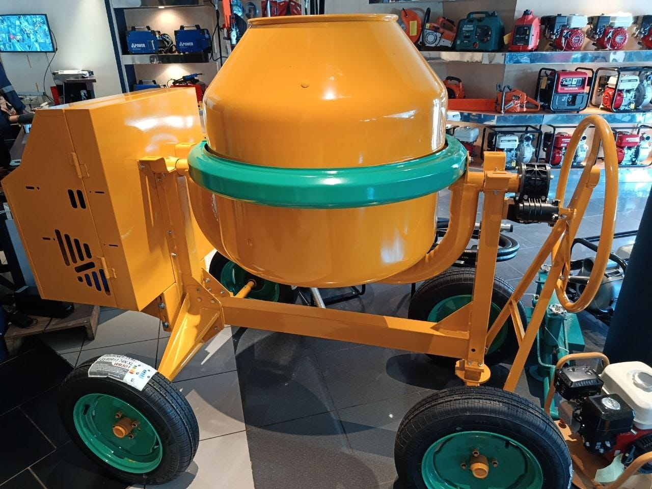 Linosella 4W 360 S14A concrete mixer — orange drum with green wheels, displayed in BOLD Industrial showroom